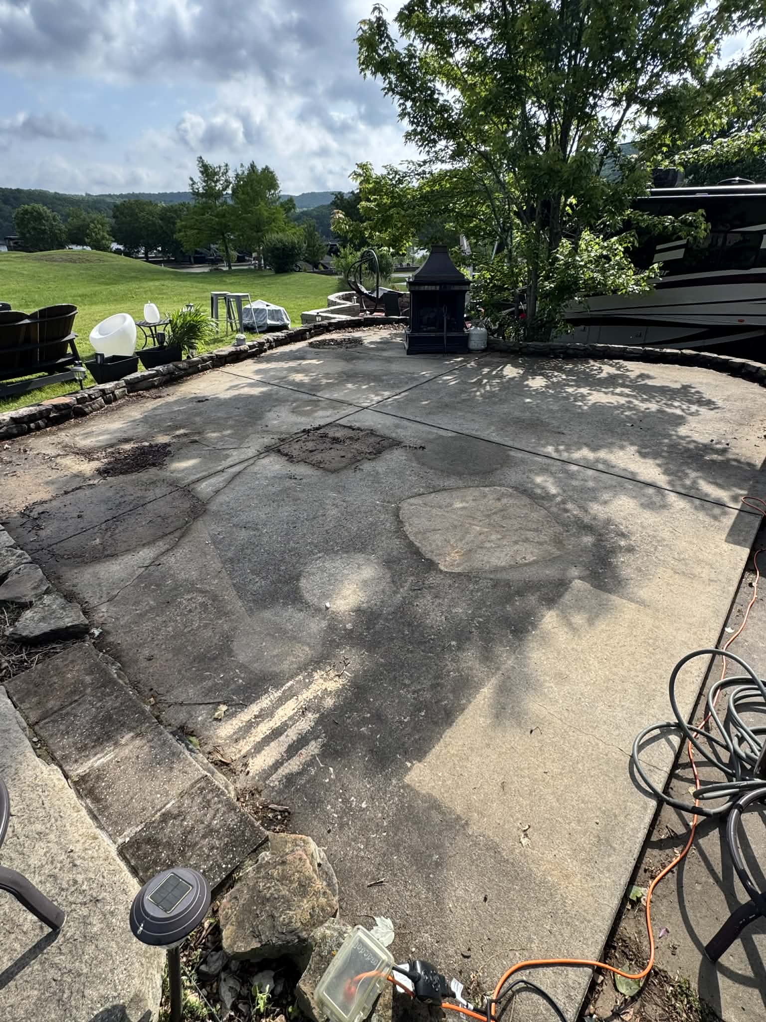Concrete patio cleaning before and after — pressure washing Branson MO by TF Exterior Group
